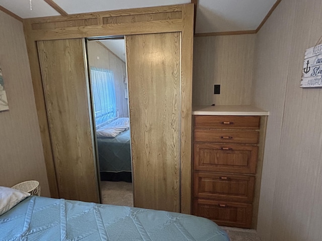 11240 Mohawk Path, Lakeview, OH 43331 - carpeted bedroom featuring wood walls, a closet, and ornamental molding
