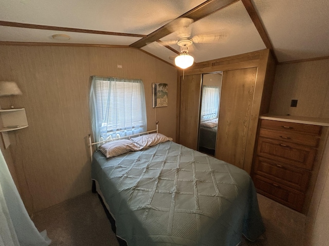 11240 Mohawk Path, Lakeview, OH 43331 - bedroom with lofted ceiling, wood walls, a closet, and ceiling fan