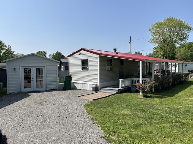11240 Mohawk Path, Lakeview, OH 43331 - rear view of property featuring a porch, a lawn, cooling unit, and an outdoor structure