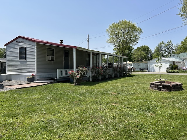 11240 Mohawk Path, Lakeview, OH 43331 - back of house featuring a yard, a porch, cooling unit, and a fire pit