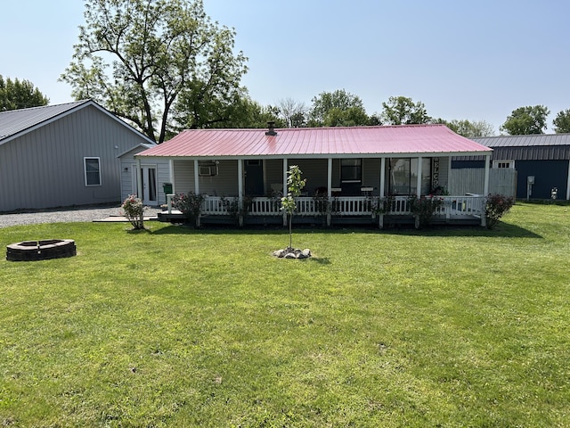 11240 Mohawk Path, Lakeview, OH 43331 - back of house featuring an outdoor fire pit, covered porch, a lawn, and metal roof