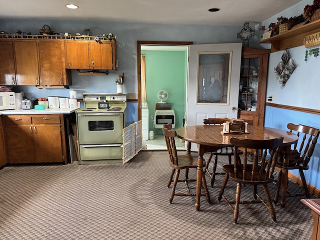 5062 Mercer Van Wert County Line Rd, Rockford, OH 45882 - kitchen featuring electric range, brown cabinetry, light countertops, dark colored carpet, and white microwave