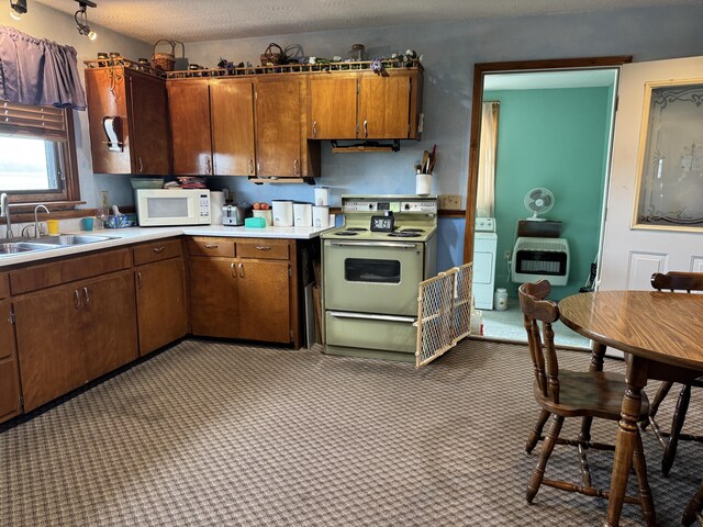 5062 Mercer Van Wert County Line Rd, Rockford, OH 45882 - kitchen featuring electric range oven, white microwave, light countertops, heating unit, and washer / dryer