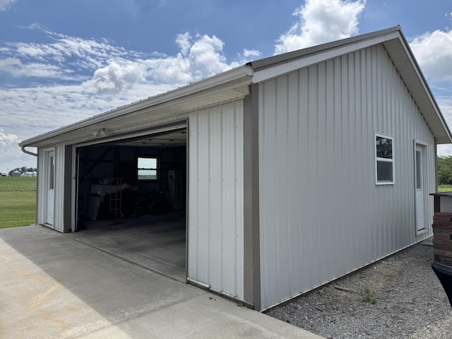 5062 Mercer Van Wert County Line Rd, Rockford, OH 45882 - view of home's exterior featuring an outdoor structure, concrete driveway, and a detached garage