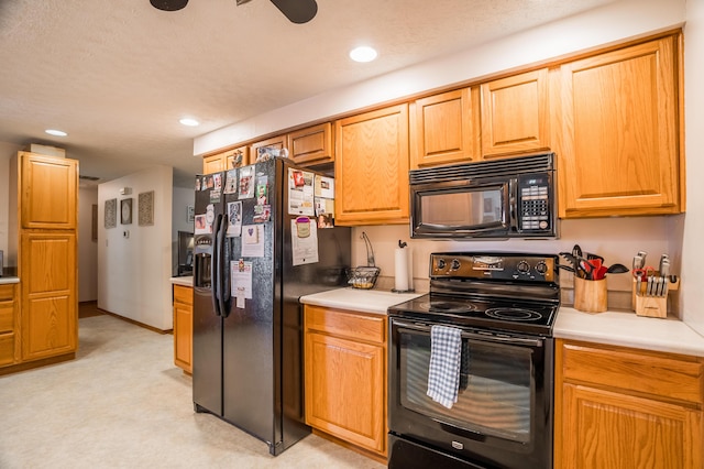 kitchen with recessed lighting, light countertops, and black appliances