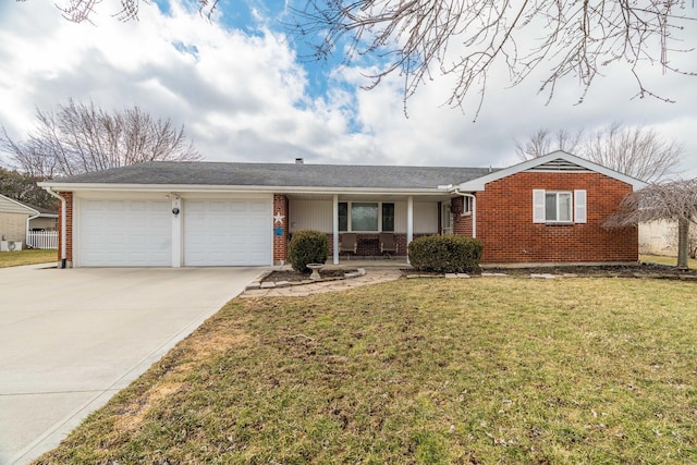 single story home featuring a garage, concrete driveway, brick siding, and a front lawn