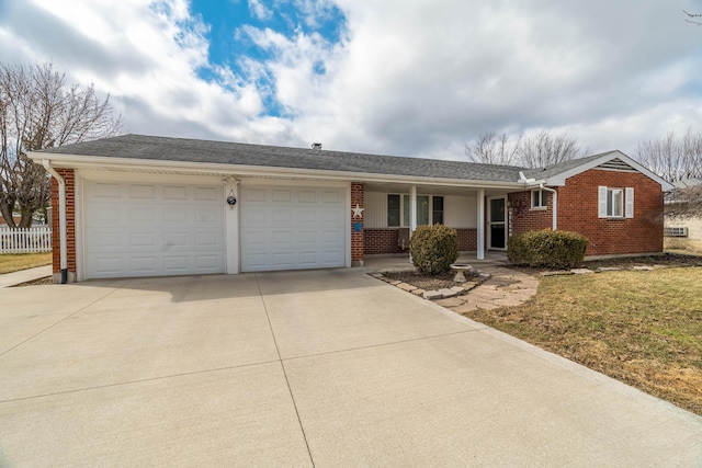 ranch-style home featuring covered porch, brick siding, driveway, and an attached garage