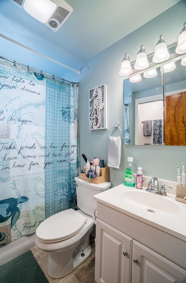 bathroom featuring toilet, visible vents, vanity, tile patterned floors, and shower / bath combo