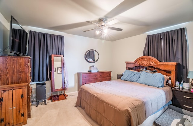 bedroom with baseboards, a ceiling fan, and light colored carpet