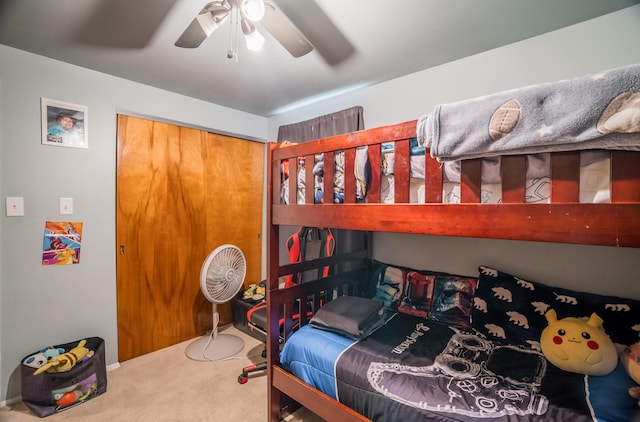 carpeted bedroom featuring a closet and ceiling fan