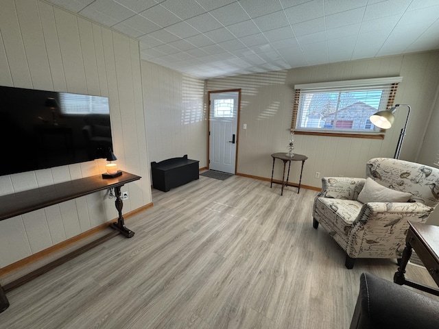 entryway featuring wooden walls and light hardwood / wood-style floors