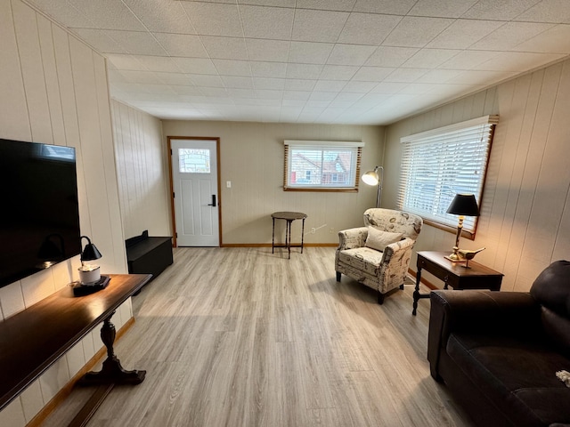 living room featuring wooden walls and light wood-type flooring