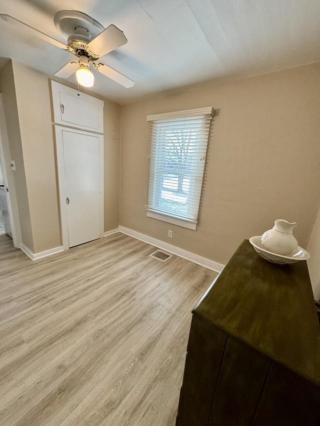 bedroom with ceiling fan, a closet, and light wood-type flooring