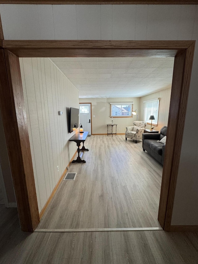 interior space featuring hardwood / wood-style flooring and wood walls