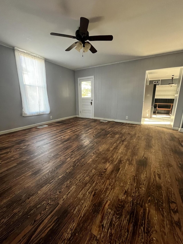 interior space featuring a fireplace, dark wood finished floors, visible vents, and baseboards