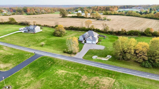 birds eye view of property with a rural view