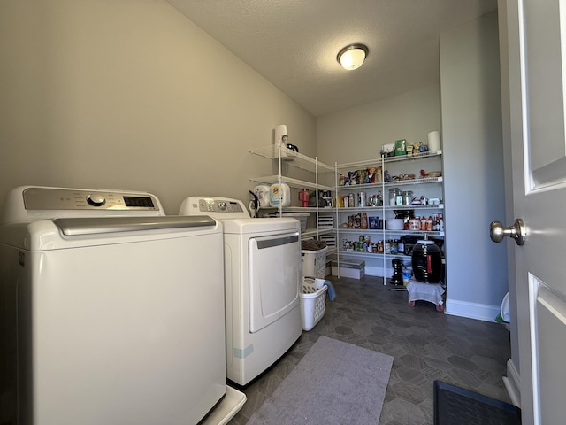 washroom featuring baseboards, a textured ceiling, laundry area, and separate washer and dryer