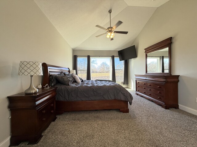 bedroom with carpet, baseboards, vaulted ceiling, and ceiling fan