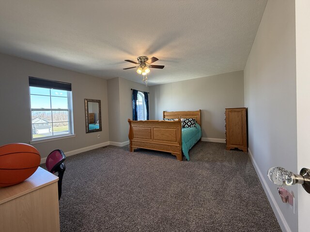 bedroom featuring baseboards, carpet flooring, a textured ceiling, and ceiling fan