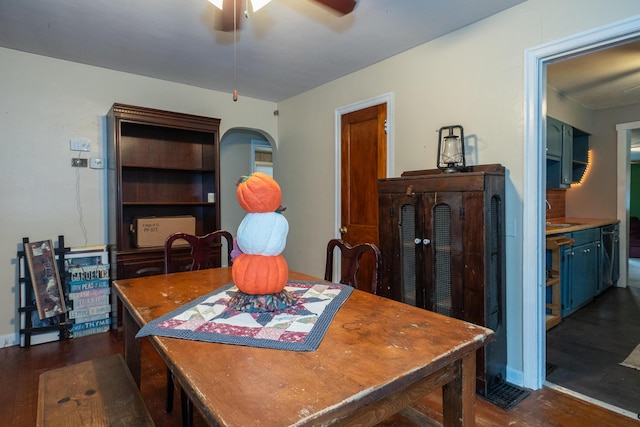 dining space with dark wood-type flooring, ceiling fan, and sink