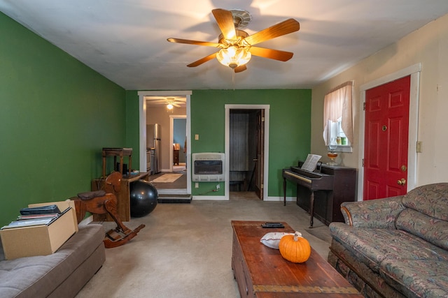 carpeted living room with ceiling fan and heating unit