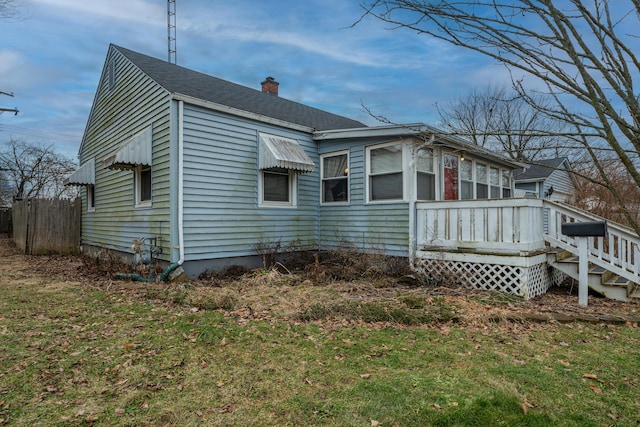 view of side of property with a yard