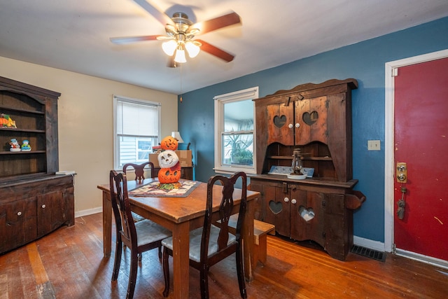 dining space with hardwood / wood-style floors and ceiling fan