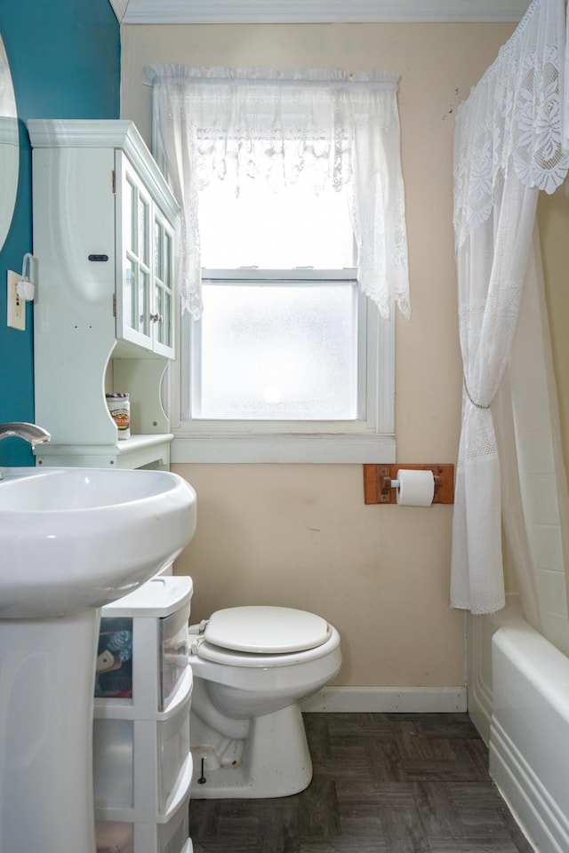 bathroom with shower / bathtub combination with curtain and toilet