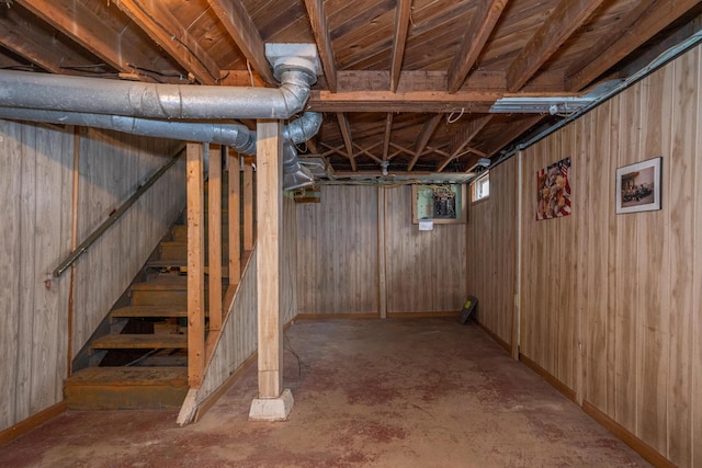 basement featuring wooden walls