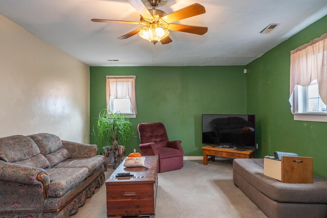 living room featuring light colored carpet and ceiling fan