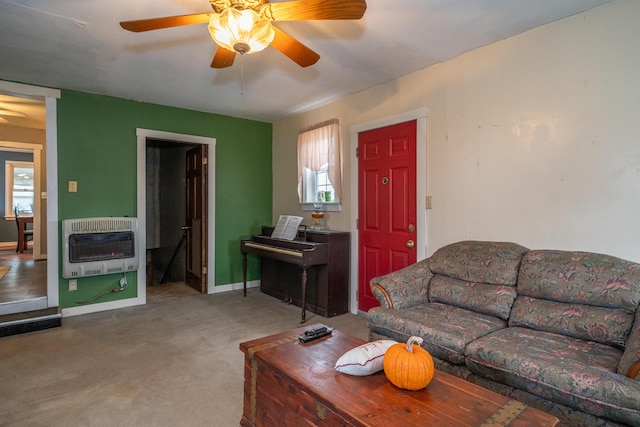 living room featuring heating unit, ceiling fan, and carpet flooring