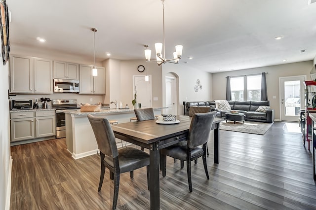 dining room with a notable chandelier and dark hardwood / wood-style flooring