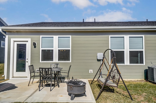 rear view of property featuring central AC, a patio, and a fire pit