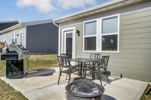 view of patio / terrace with area for grilling and an outdoor fire pit