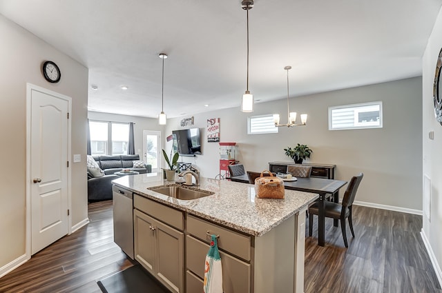 kitchen featuring sink, dark hardwood / wood-style flooring, a kitchen island with sink, stainless steel dishwasher, and light stone counters