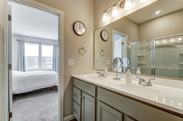 bathroom featuring vanity and a shower with door