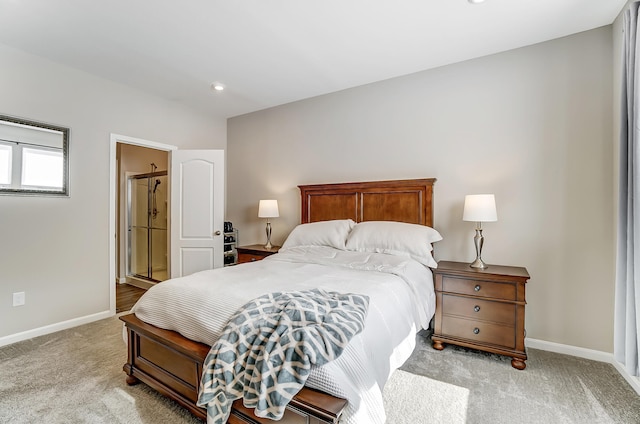 carpeted bedroom featuring ensuite bath