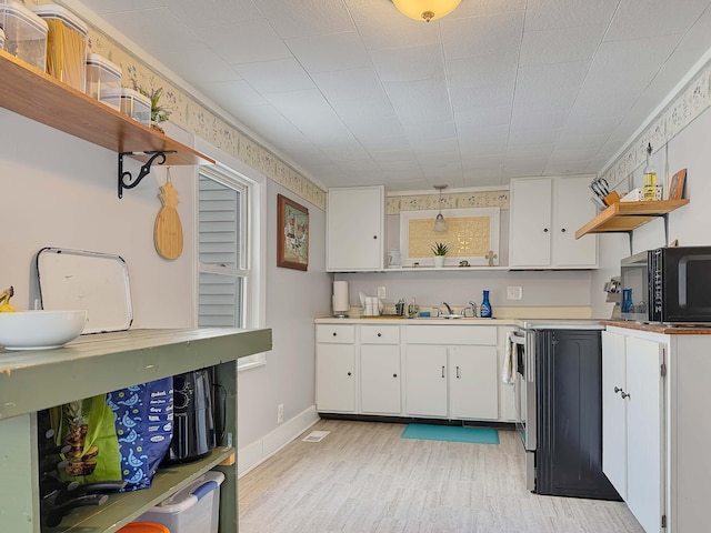 kitchen with light wood-style flooring, white cabinetry, open shelves, and light countertops