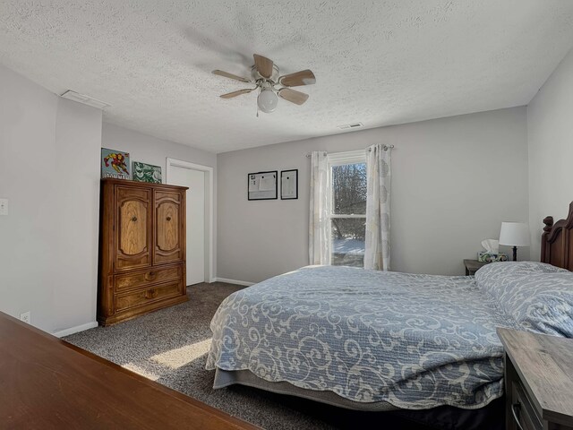 carpeted bedroom featuring baseboards, a textured ceiling, visible vents, and a ceiling fan