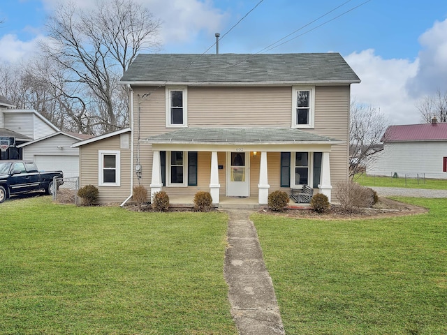 view of front of property with a porch, a garage, and a front lawn