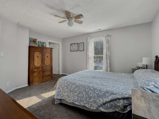 carpeted bedroom with baseboards, a textured ceiling, visible vents, and a ceiling fan