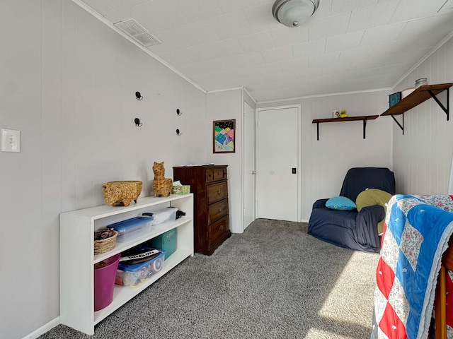 carpeted bedroom featuring ornamental molding and visible vents