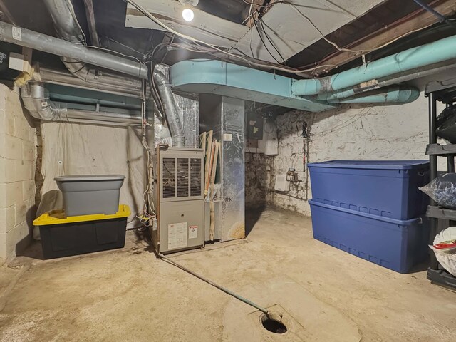 utility room featuring heating unit