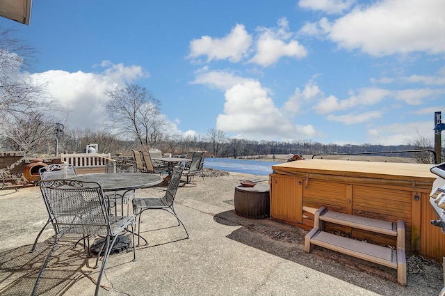 view of patio with a hot tub and outdoor dining area