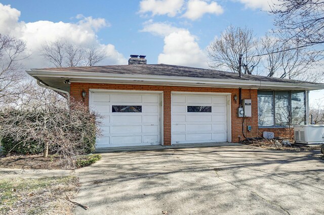 garage featuring concrete driveway