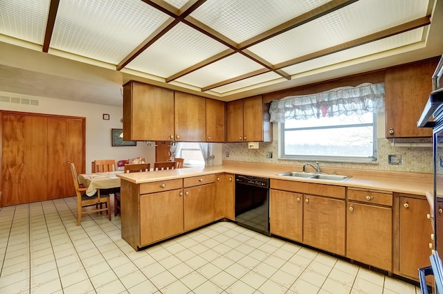 kitchen with a sink, black dishwasher, and light countertops