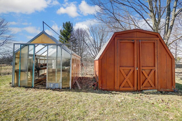 view of greenhouse featuring a lawn