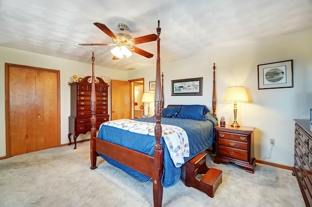 bedroom with light colored carpet, a ceiling fan, and baseboards