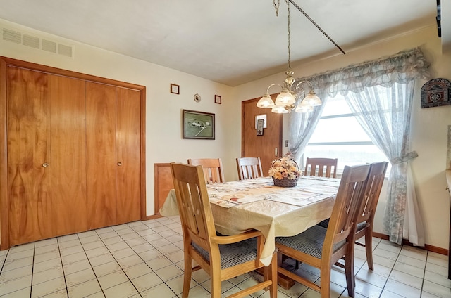 dining space featuring light tile patterned floors, visible vents, baseboards, and a chandelier