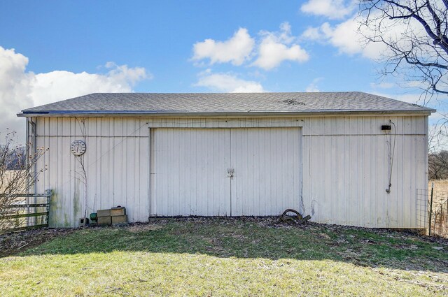 view of pole building with a yard and fence